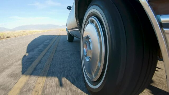 Cool Shot of Retro Station Wagon Wheel while Driving on Deserted Road 