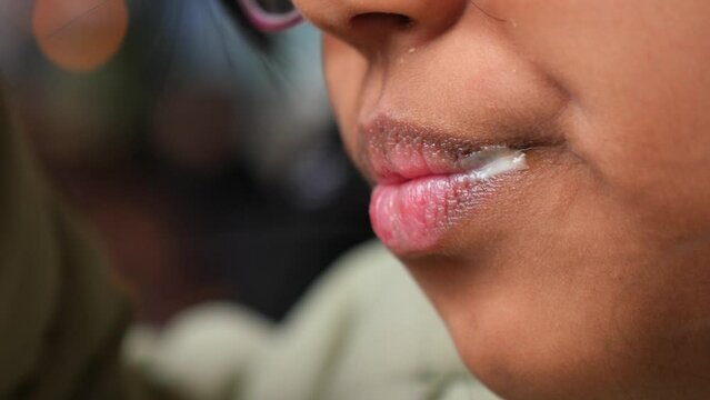 Child chewing food with open wide mouth,