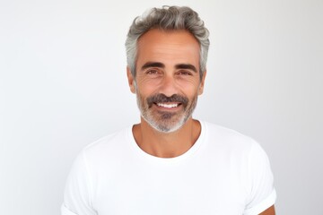 Portrait of handsome mature man in white t-shirt looking at camera