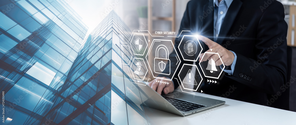 Poster cybersecurity and data protection concept, businessman using laptop to defending the cyberspace, shi