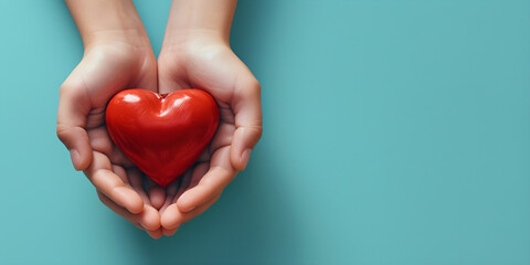 Young women hands holding red heart on blue background. Health care, donate, and family insurance concept.