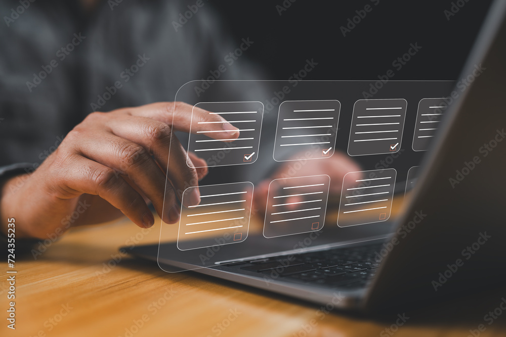 Aufkleber Document management system DMS. Assessment form, questionnaire, checklist and clipboard task management. Businessman working on laptop computer productivity checklist and filling survey form.
