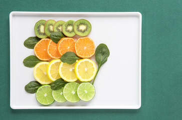Kiwi, Orange, Lemon and Lime Slices with Spinach Leaves