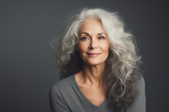 Portrait of a beautiful mature woman with long wavy hair.