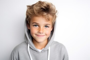 Portrait of a cute little boy in a gray hoodie.