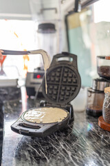 Cook preparing a waffle in a food truck