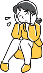 頭を抱えて苦しむ女性