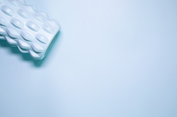 A blue massage foam roller and isolated on a blue background. Close-up. Foam rolling is a self myofascial release technique. Concept of fitness equipment.