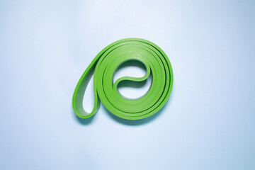 Fitness elastic band for sport isolated on blue background.