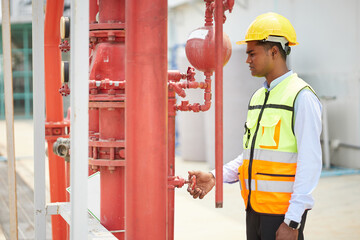 worker checking and fixing water pipes in the factory