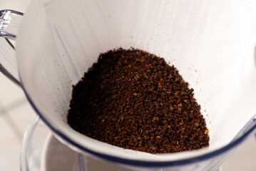 Ground coffee beans in a filter drip holder. 