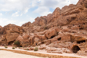 Rocks dotted with the many caves carved by Nabatean craftsmen in Nabatean Kingdom of Petra in the Wadi Musa city in Jordan