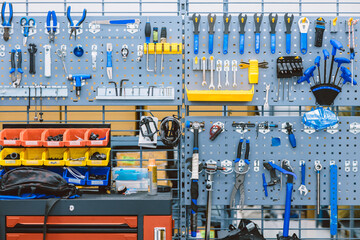 set of bike tools in bicycle professional service workshop for fix repair assembly set hanging on wall panel tool holder