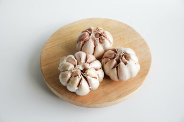Onion on wooden board in white background.