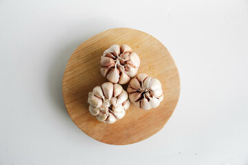 Onion on wooden board in white background.