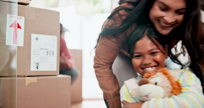 Box, family and children while playing in new home for mortgage, investment and moving house at front door. Parents, kids and cardboard or excited for ownership, relocation and commitment with loan