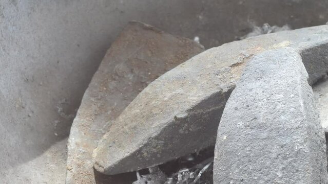 Molten lead being poured into a mold with visible steam, close up