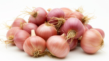 Pile of fresh, pink-hued shallots on white.