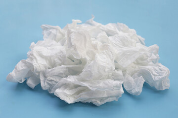 Obraz premium Crumpled tissue paper. Facial tissue on blue background.