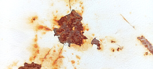 Rusty and worn metal layer with spilled paint