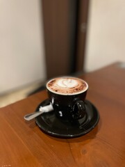 A cup of delicious hot chocolate on the wooden table