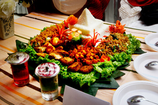 Tumpeng or tumpeng rice is a dish served at Javanese, Balinese, Madurese and Sundanese traditional ceremonies where the rice is served in a cone shape and arranged together with side dishes.