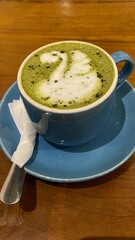 A cup of hot green tea latte in for coffee break
