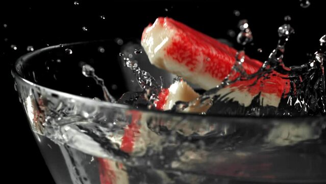 Crab sticks fall into the water. Filmed on a high-speed camera at 1000 fps. High quality FullHD footage
