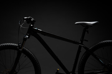 Black mountain bicycle on black background