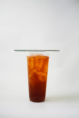 Take away iced tea in plastic cup with straw isolated in white background