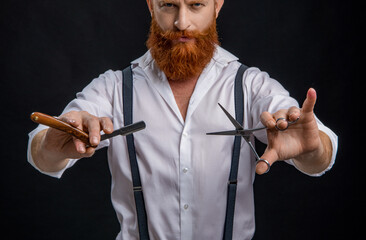 Hairdresser at barbershop isolated on black. Hairdresser man. Professional barber man hold retro razor. Handsome hairstylist with haircut. Barbershop. Man hairdressing and barbering. Timeless retro