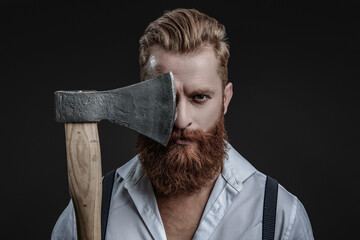 Brutal man in suspenders with ax isolated on black. Mature redhead man with hairstyle. Brutal male...