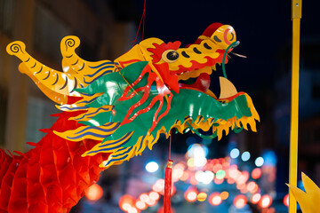 Close-up photo of a red Chinese dragon god's head at night with bokeh during the Chinese New Year...