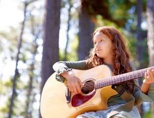 Nature, camp and girl kid with guitar for entertainment, talent or music in woods or forest....