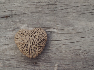 Yarn hearts on an old wooden background, vintage style for Valentine's Day.