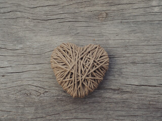 Yarn hearts on an old wooden background, vintage style for Valentine's Day.