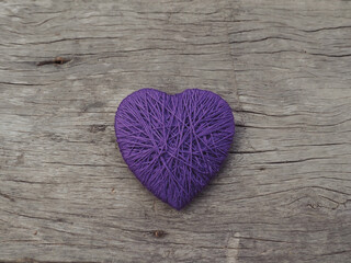 Obraz premium Yarn hearts on an old wooden background, vintage style for Valentine's Day.