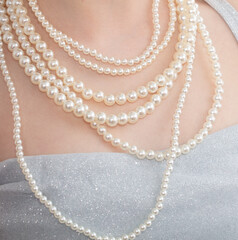 Beads with pearls on the girl's neck. Close-up