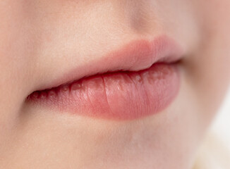 Fototapeta premium Close-up of a little girl's lips. Macro