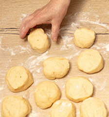 Pieces of dough on the table in flour