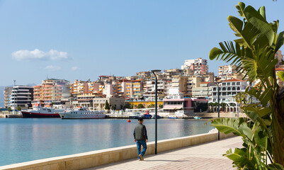 Picturesque cityscape of Albanian city of Sarande on coast of Ionian Sea overlooking modern...