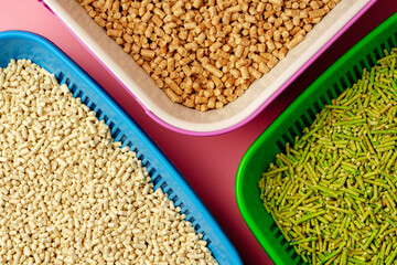 Pet litter box with bio filler on pink background