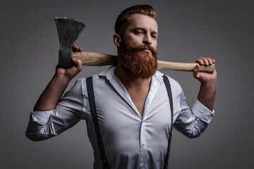 Masculinity of bearded man with axe isolated on grey. Caucasian brutal man with beard and...