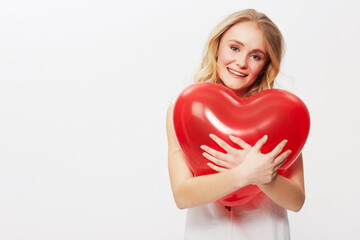 Woman, portrait and heart balloon for love in studio, happy and valentines day in casual fashion. Model, positive and face by red care symbol, affection and wellness in mockup by white background