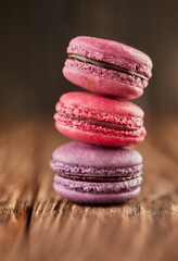 Fototapeta na wymiar Fresh macarons of different colors and flavors on a wooden background