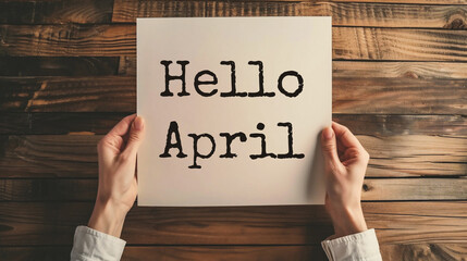 woman holding card with hello april lettering - obrazy, fototapety, plakaty