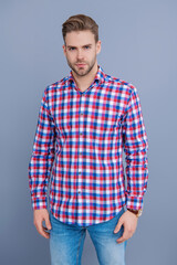Man isolated on grey. Millennial man wearing checkered shirt. Casual style of millennial man. Portrait of young man in casual style shirt. Stylish face portrait of unshaven guy. Stylish Composure