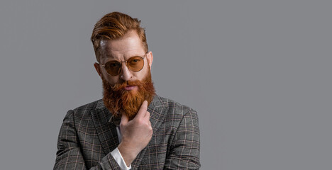 Redhead man in menswear tuxedo. Man wear elegant formal menswear. Elegance of bearded man in formal suit. Tuxedo man in menswear isolated on grey. Copy space. Effortless elegance