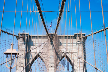 Fototapeta premium New York bridge connecting Manhattan and Brooklyn. Brooklyn landmark. Brooklyn bridge in New York. Architecture of historic bridge in Brooklyn. Bridge of New York city