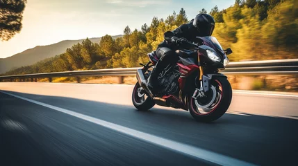 Zelfklevend Fotobehang Motorcycle rider in helmet and leather jacket racing on asphalt road with blurred background © Ameer